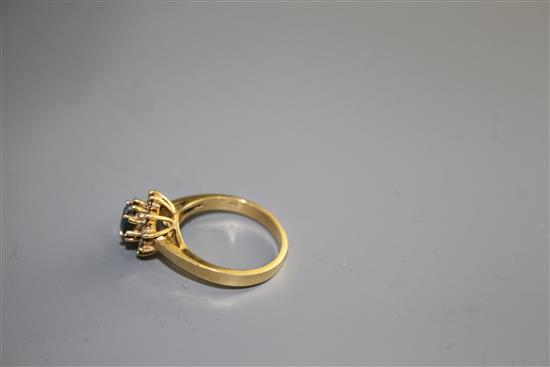 A modern 18k yellow metal, chrysoberyl? and diamond set oval cluster ring, size M, gross weight 4.2 grams.
